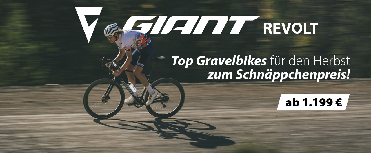 Ein Mann fährt auf einem Gravel Bike eine Schotterstraße entlang.